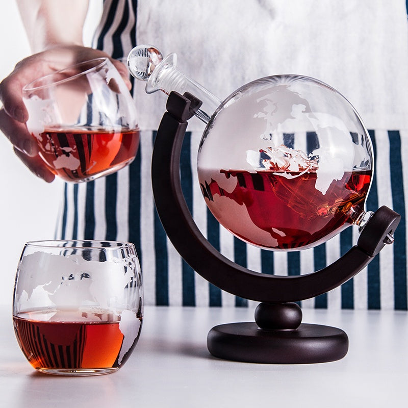 Globe design decanter set complete with two matching etched glasses.