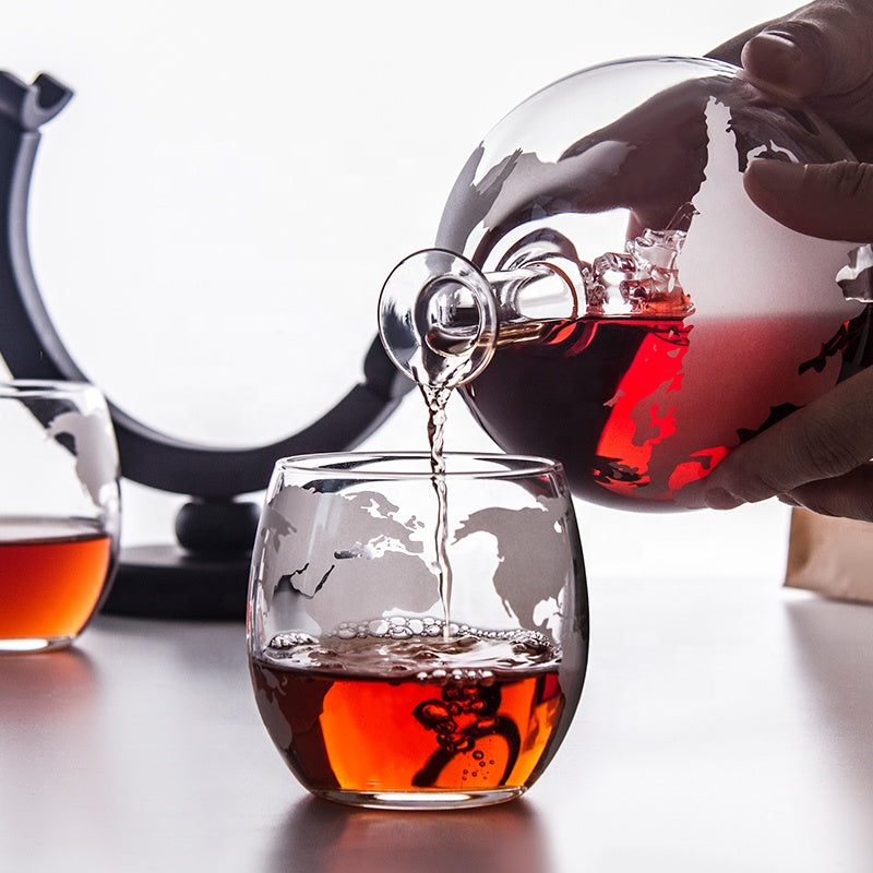 Premium liquor decanter featuring etched globe detailing on the glass.