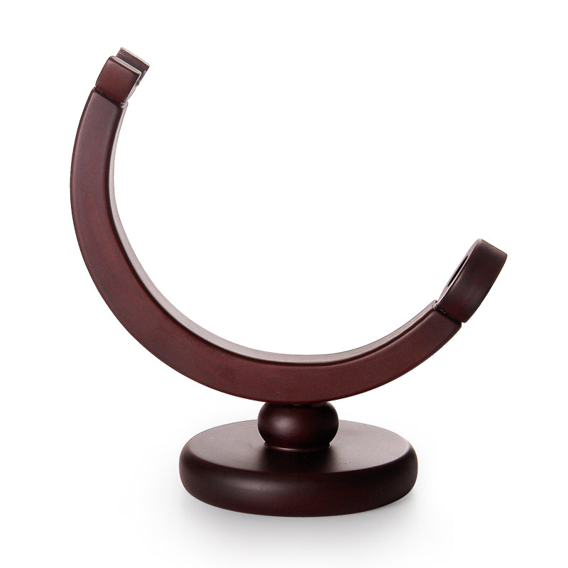 Close-up detail of the wooden frame supporting the glass globe decanter.